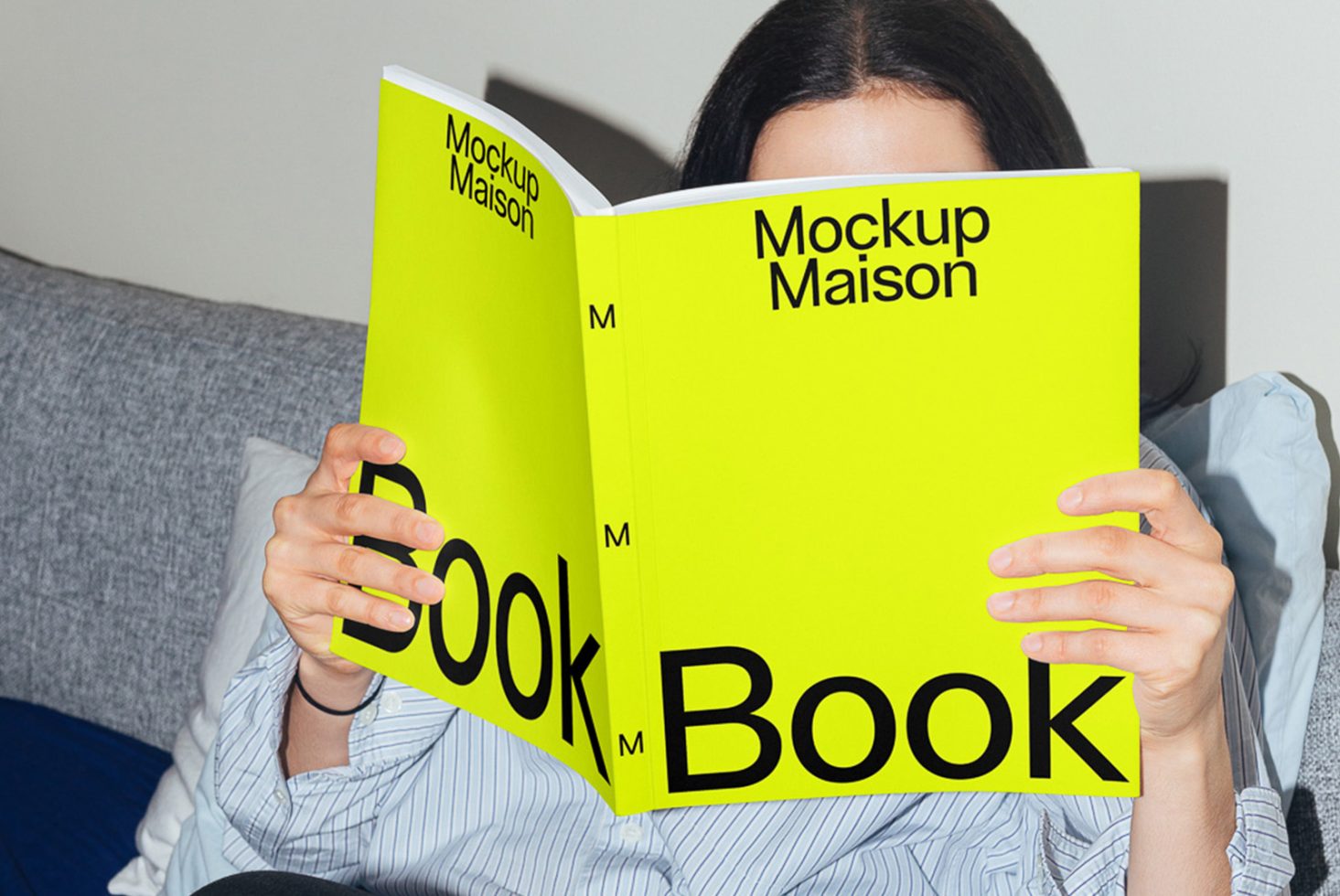 Person holding a vibrant yellow book mockup design with visible cover in a casual setting, ideal for product display on digital asset marketplace.