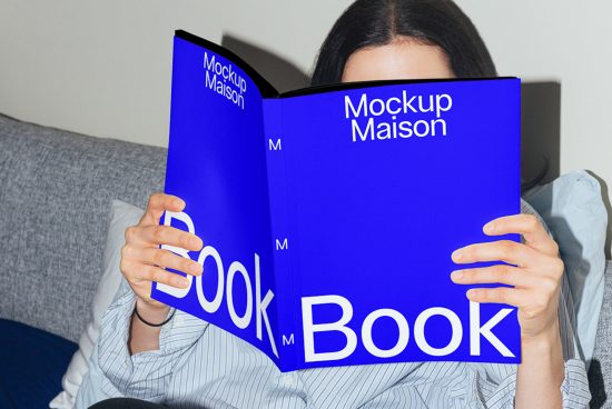 Person holding a blue book mockup with visible title, ideal for graphic designers and publishing presentations.