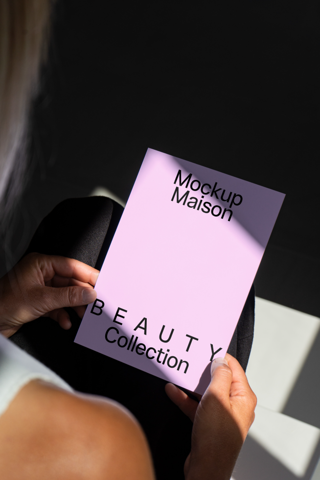 Person holding beauty collection card mockup with pink background suitable for designers. Perfect for showcasing fonts, templates, and graphic elements.