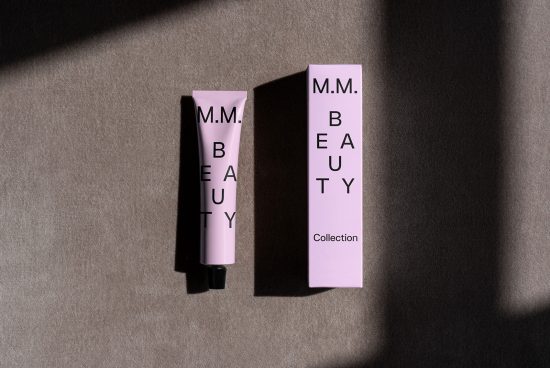 Mockup of a pink cosmetic tube and box with minimalist black typography design labeled MM Beauty Collection ideal for skincare branding and packaging design.
