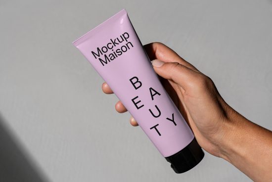 Beauty product tube mockup being held by a hand. Perfect for showcasing cosmetics branding. Ideal for designers creating templates, mockups, and graphic designs.