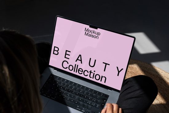 Laptop mockup with pink screen displaying beauty collection text ideal for showcasing digital designs to professional designers seeking quality mockups and templates