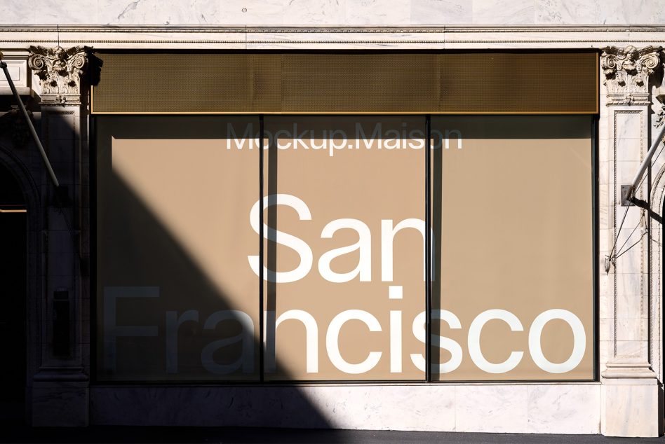 Large beige storefront window display on ornate classical building facade