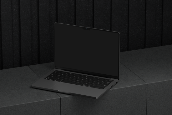 Mockup of a sleek open laptop on a dark textured surface suitable for digital assets designers ideal for showcasing UI designs templates or branding mockups.