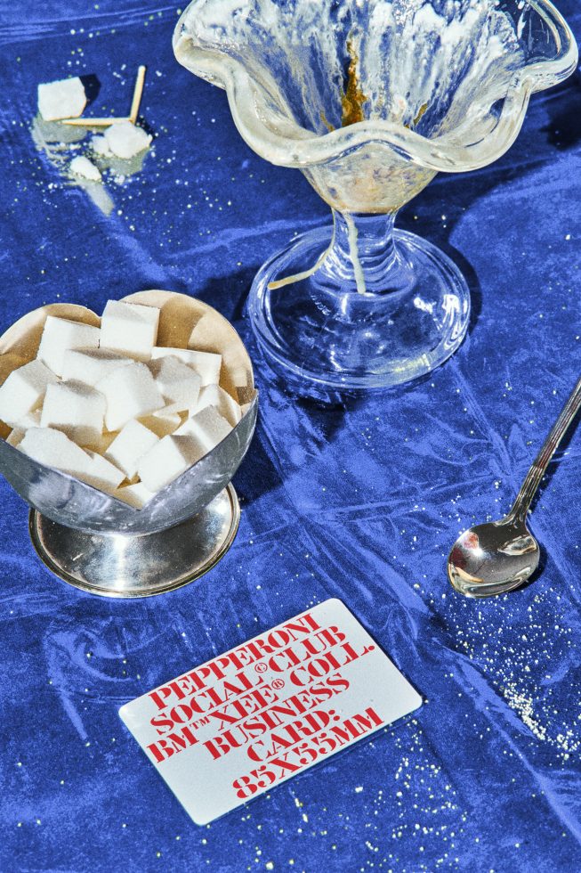 Glass bowl and sugar cubes on blue fabric with business card, perfect for templates, graphics, mockups, designers, digital assets, food styling, photography.