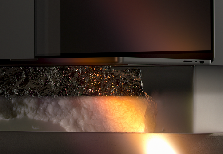 Laptop displaying warm amber glow with textured metallic surface below