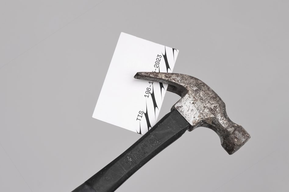 Business card held by a rusty hammer mockup. Suitable for showcasing business card designs. Perfect for designers. High resolution and editable template.