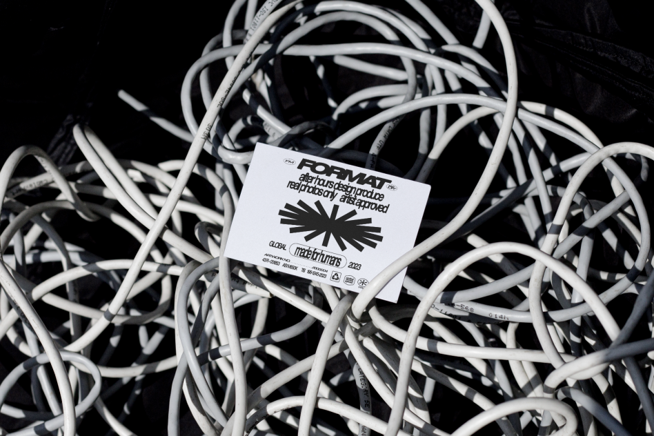 Bunch of tangled white cables with a FORMAT card displaying artist-approved design. Ideal for designers seeking unique graphics and templates for digital projects.