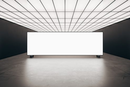 Minimalist mockup of a large indoor billboard with a white light grid ceiling. Perfect for showcasing designs and advertisements in a modern setting.