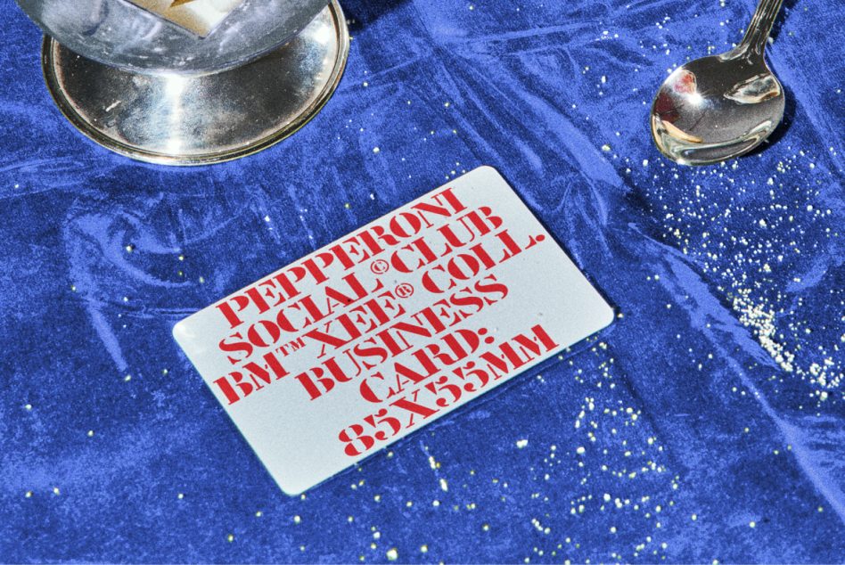 Flat lay of silver spoon on shimmering blue velvet with white business card mockup