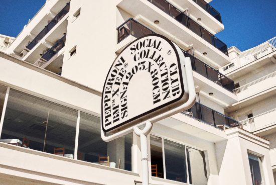 Modern building exterior with a retro-style sign promoting Pepperoni Social Club Collection, suitable for mockups. Clear blue sky in the background.