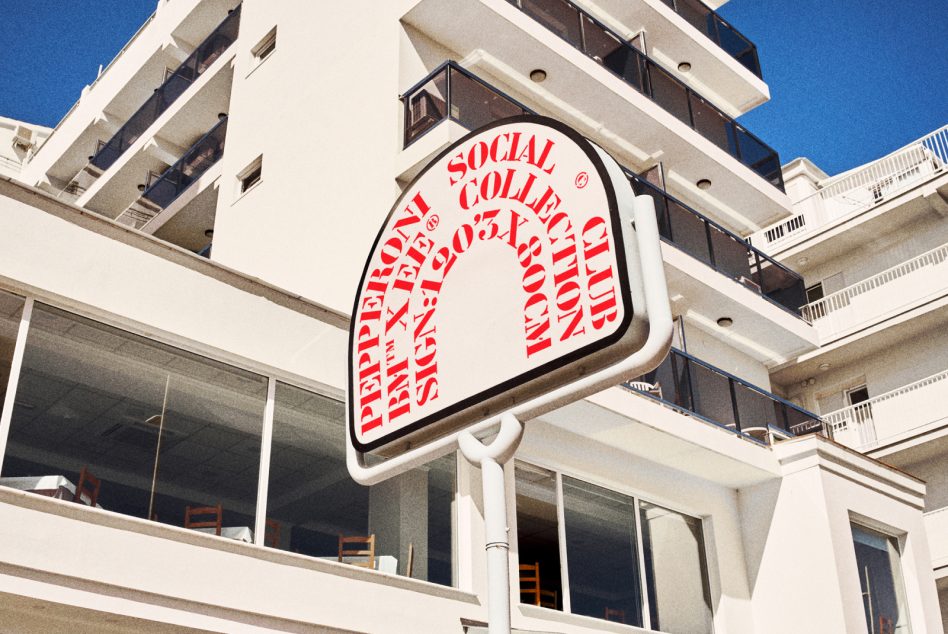 Vintage style mockup featuring an outdoor sign with red typography in front of a modern building, ideal for showcasing branding concepts and logo presentations.