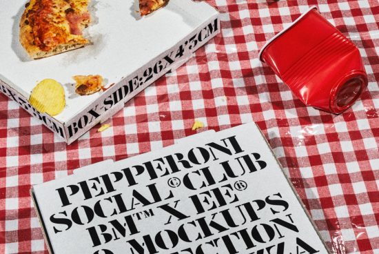 Pizza box with bold typography on a red and white checkered tablecloth with a crushed red cup, ideal for pizza packaging mockups and food branding designers.
