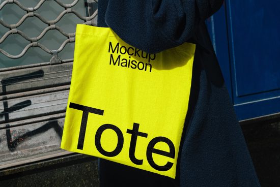 Yellow tote bag mockup Maison in use outdoors. Ideal for branding projects and showcasing logo designs. High-quality tote bag mockup for designers.