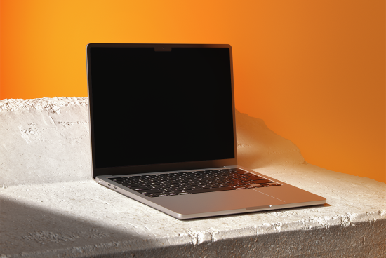 Laptop mockup with blank screen on concrete surface and orange background perfect for digital assets designers showcasing templates graphics and UI designs