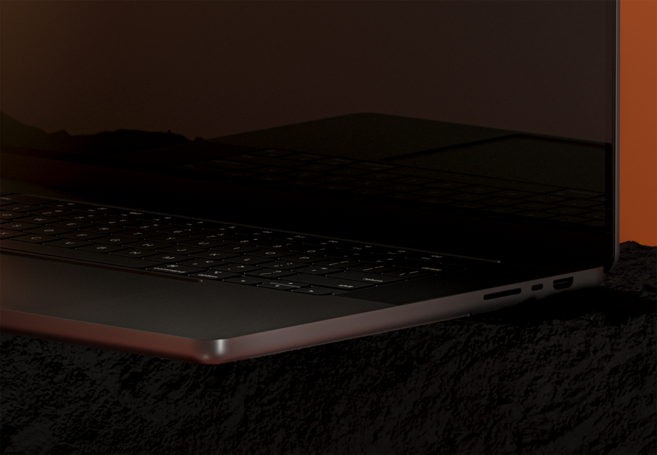 Sleek laptop mockup at an angle with copper accents, dark moody lighting, textured surface background