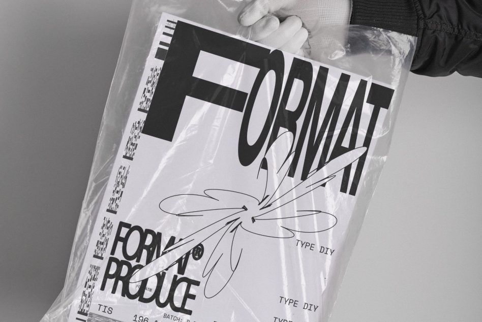 Magazine with white cover inside plastic sleeve held at an angle in hands