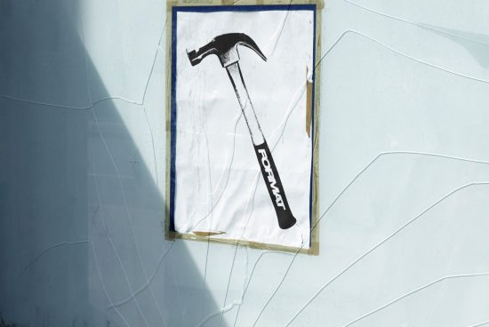 Vintage hammer poster mockup on cracked concrete wall, ideal for designers creating realistic street art or construction-themed graphics and templates.