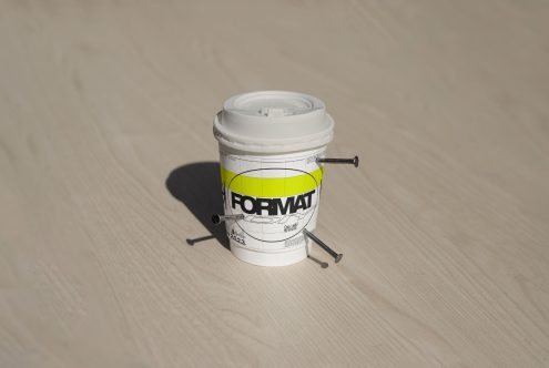 Coffee cup mockup with nails on wooden surface customizable packaging design template high-resolution format for designers branding and marketing projects.