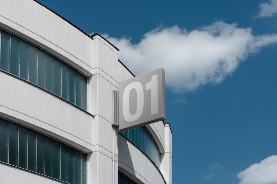 Modern building exterior with number 01 sign against clear blue sky perfect for mockups, templates, architectural presentations or graphic design projects.