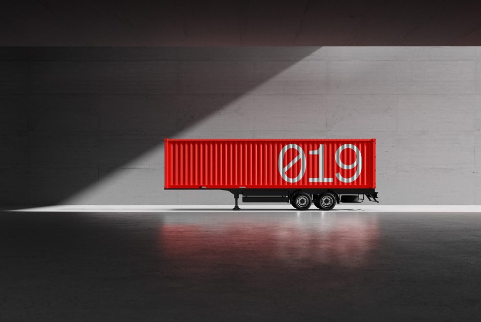 Red shipping container with 019 written in large white numbers parked indoors against a grey wall Product Mockup, Industrial Design, Container Graphics.