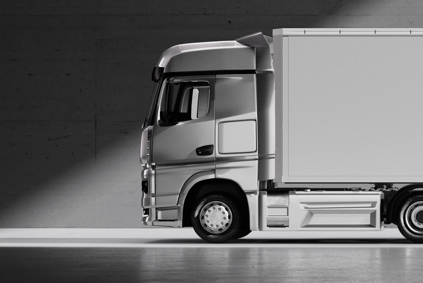 Side view of a silver truck cabin in a dark warehouse, perfect for designers in graphics, mockups, and templates. High-resolution image highlighting vehicle design.