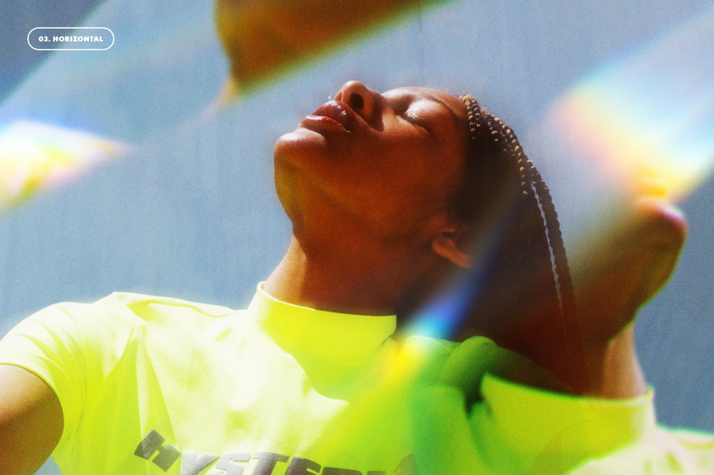 Vibrant photo of a person in a neon shirt with rainbow light reflections. Use for mockups, graphic design, or templates. Ideal for designers seeking colorful images.