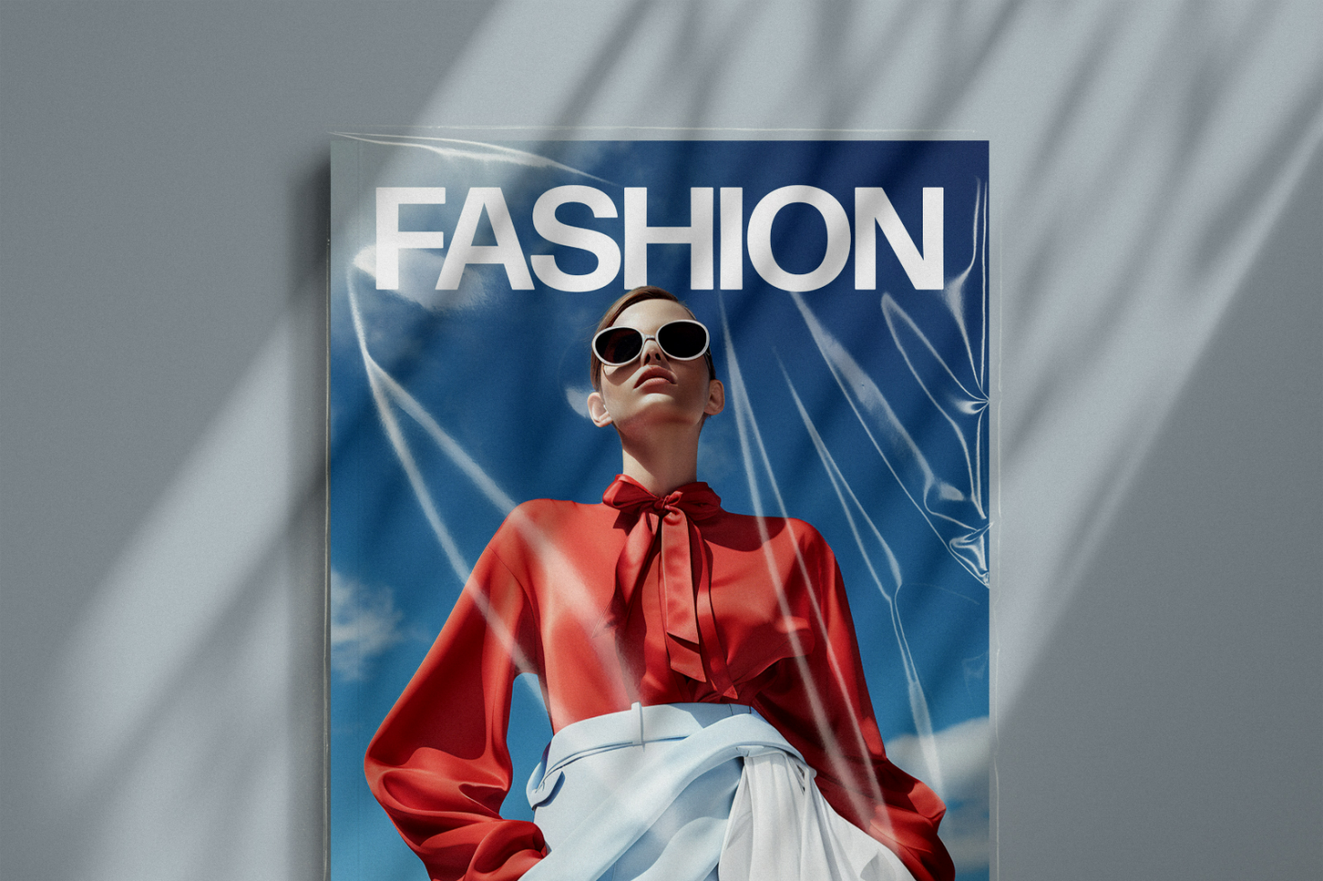 Fashion magazine mockup featuring a stylish model in sunglasses and a red blouse against a blue sky background. Ideal for designers, templates, branding.