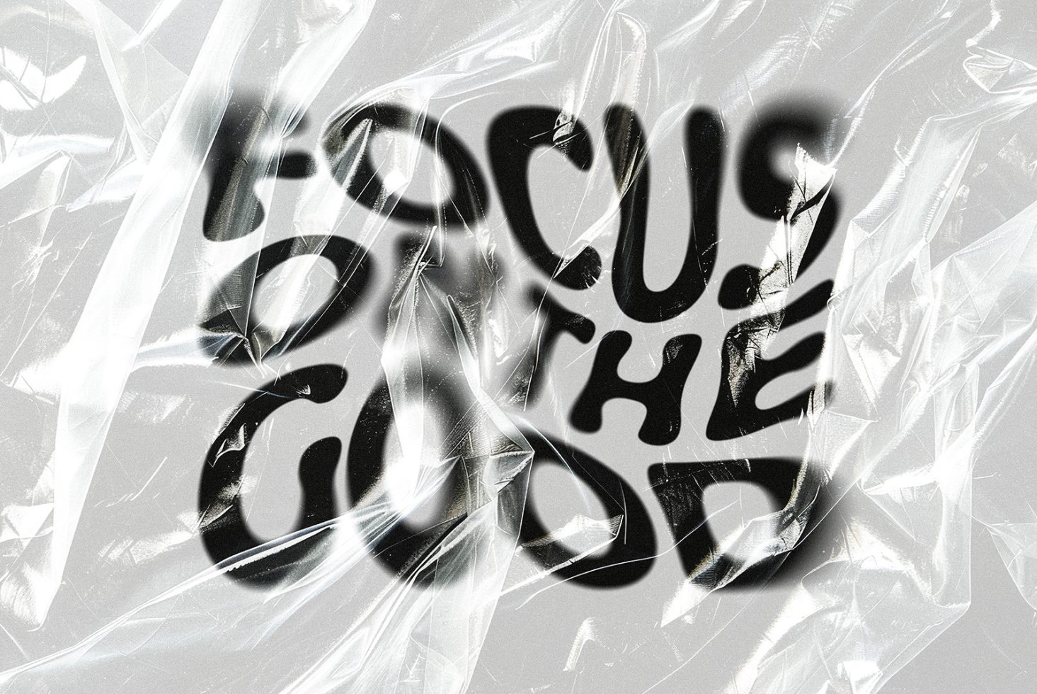 Wrinkled plastic wrap overlay with blurred black text Focus on the Good. Perfect for designers seeking unique textures, mockups, or creative typography.