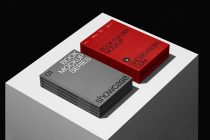Stacked gray books beside bright red folder box mockup