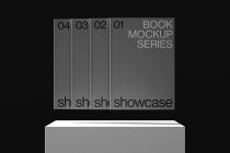 Four gray books in series with blank covers, standing upright on white platform