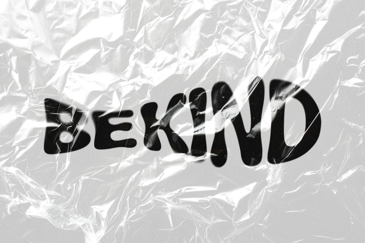 Text reading BeKind in distorted font behind crumpled plastic texture. Ideal for designers seeking unique graphic elements for creative projects.