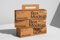 Stack of three kraft paper boxes with handle cutout stacked on each other