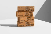 Four kraft cardboard boxes staggered in tilted stack formation