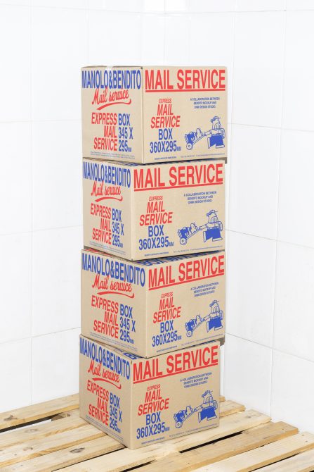 Stacked express mail service boxes on a wooden pallet against a tiled wall background mail packaging mockup cardboard design delivery boxes template stock photo