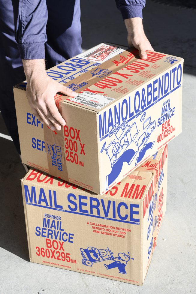 Two brown cardboard boxes with blue and red text, including Manolo&Bendito Mail Service. Ideal for packaging mockups and retail design projects.