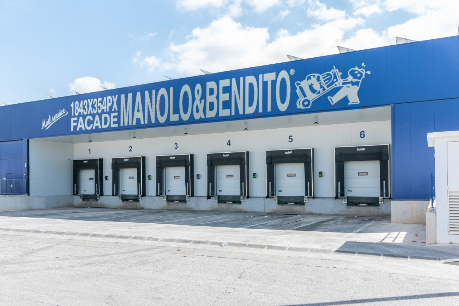 Facade mockup template featuring 1843x354px signage on an industrial building with loading docks 1-6, ideal for showcasing branding designs for designers.