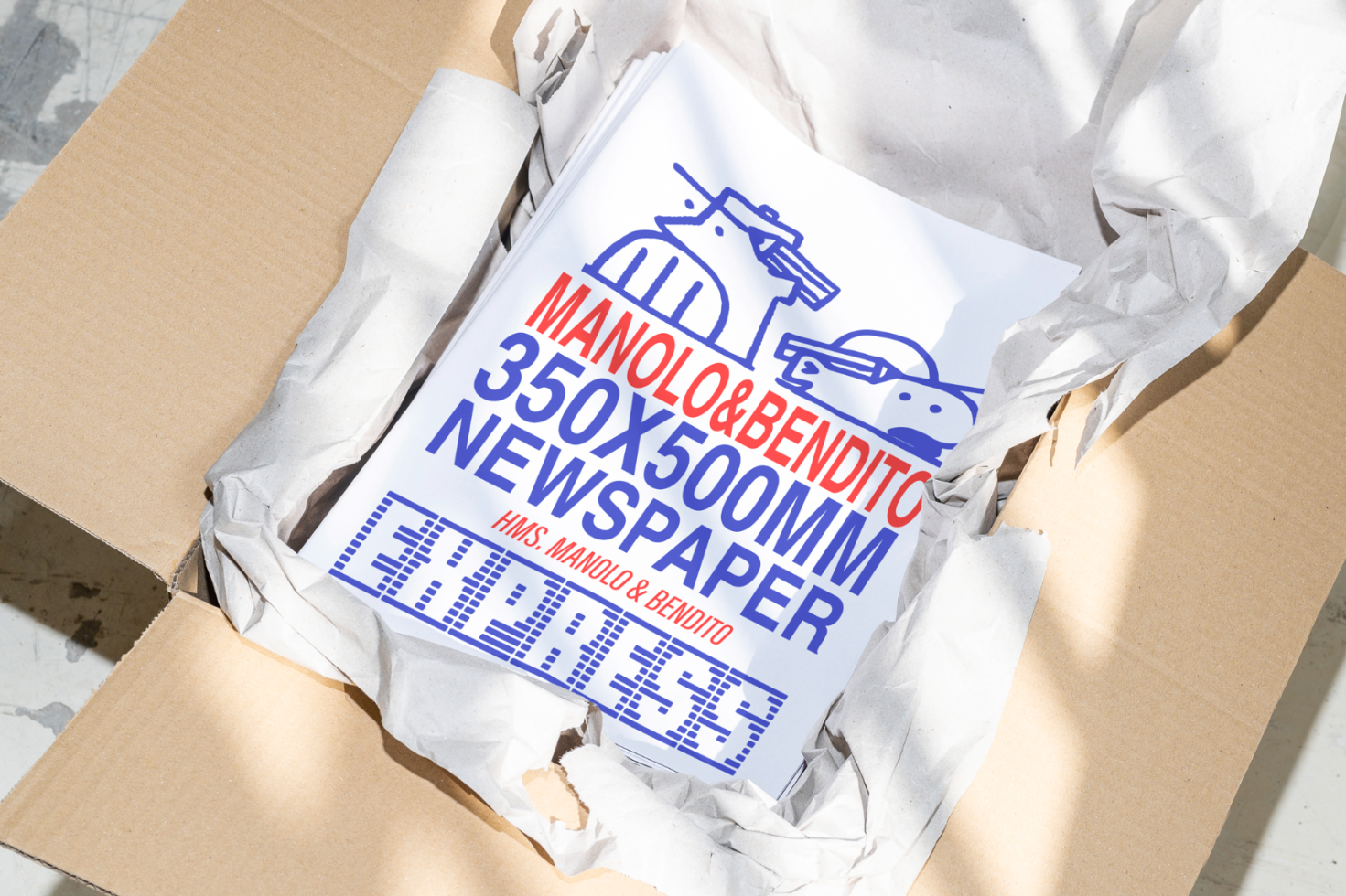 350x500mm newspaper mockup in a brown box with crumpled paper packaging, featuring bold red and blue text and simple illustrations. Graphic design resource.