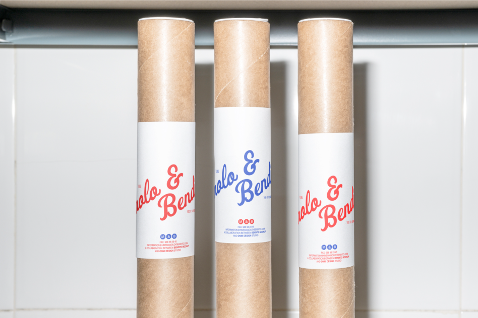 Cardboard poster tubes with white labels showing red and blue text. Ideal for mockups presentations designers packaging concepts templates graphics.