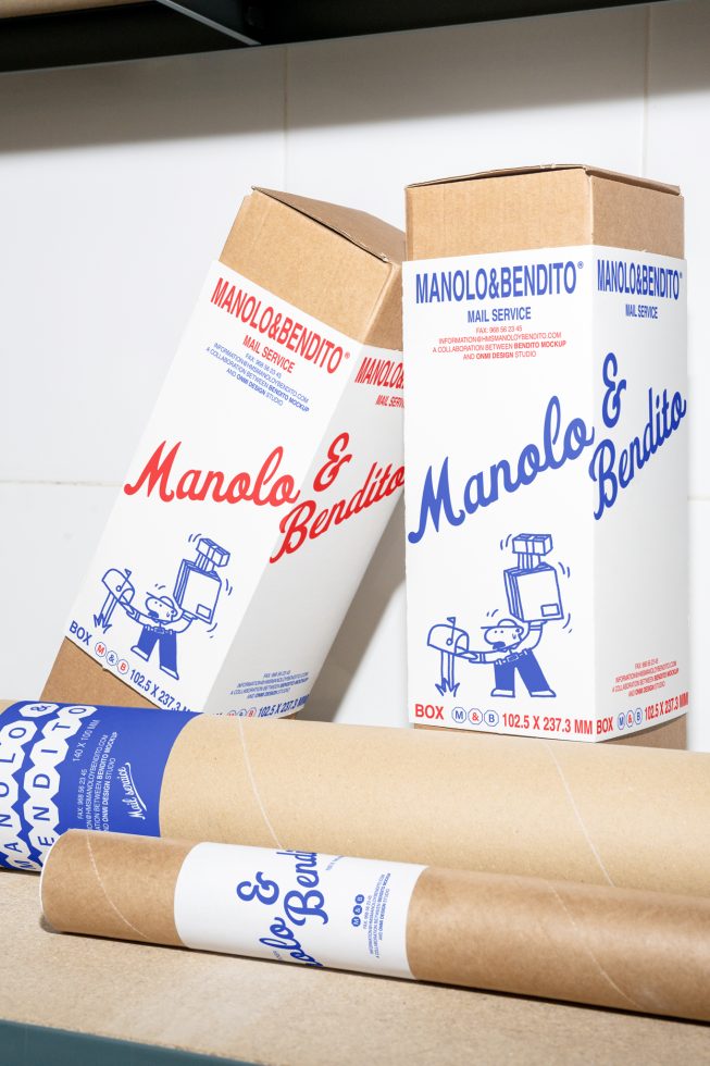 Cardboard shipping boxes and tubes with printed labels for Manolo Bendito. Ideal packaging mockup for graphic designers, branding projects, or print design.