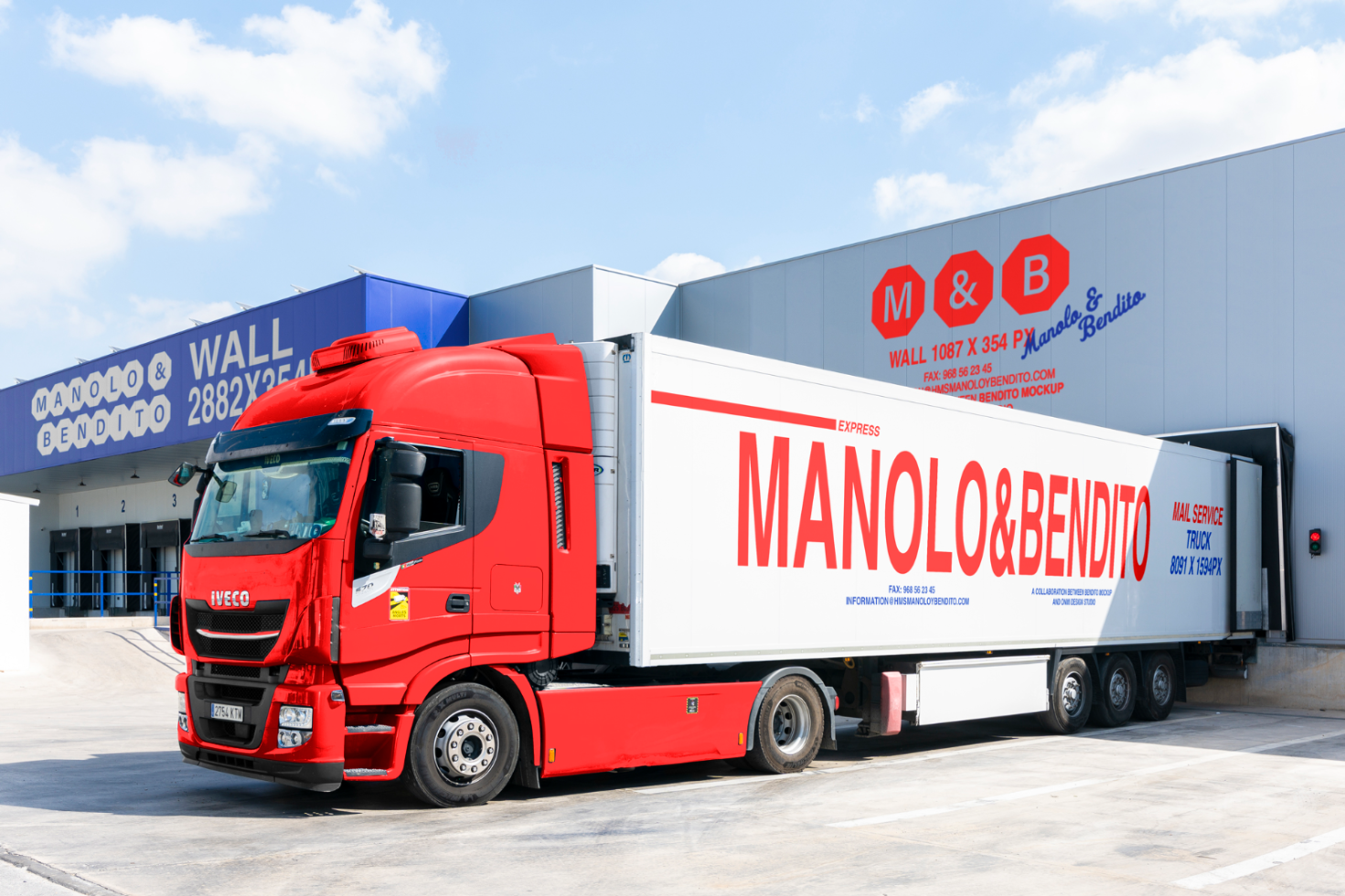 Red truck at warehouse loading dock with large branding for Manolo and Bendito. Suitable for mockups, logistics design, transportation templates.