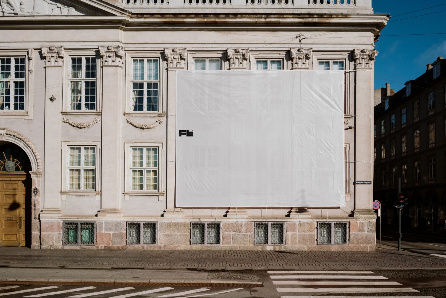 Building facade with blank banner for mockups. Ideal for graphic designers and digital asset designers. Keywords: facade mockup template blank banner.