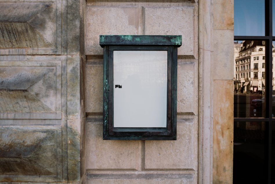 Vintage city display board mockup on a stone wall perfect for showcasing poster designs street advertising and urban graphics. Ideal for designers creatives.