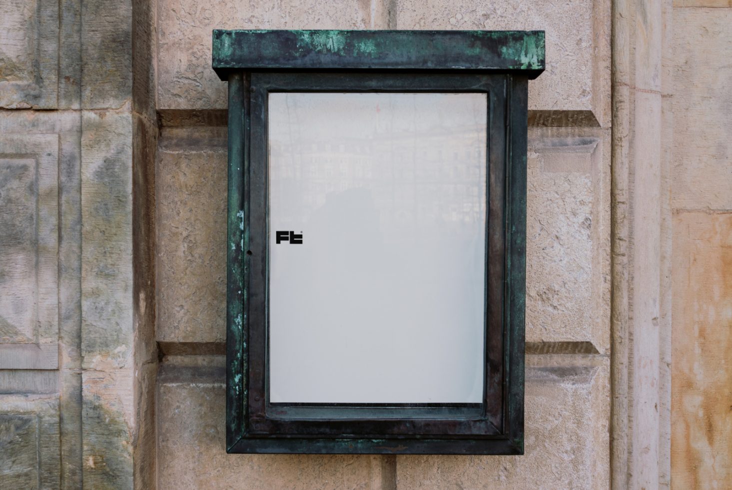 Vintage metal display case on a stone wall. Suitable for mockups, showcasing posters, artwork, or advertisements. Ideal asset for graphic designers, templates.