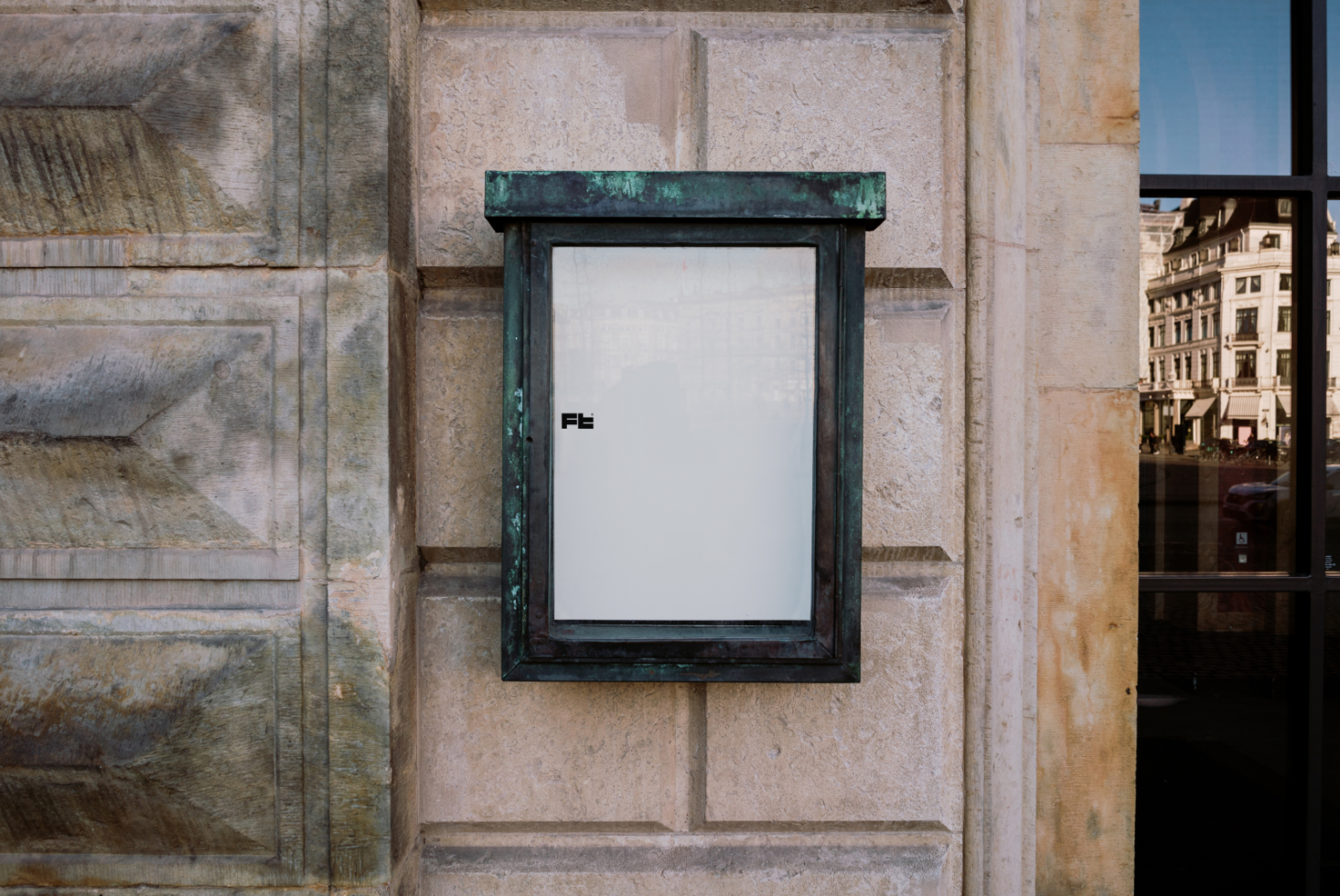 Blank storefront vertical sign mockup on a stone wall. Designers can use this template for creating custom signs. Keywords: mockup, sign, template, designers.