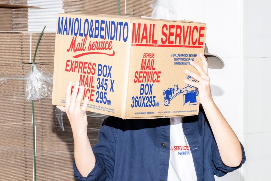 Person holding oversized mail service box with gray handle, head completely covered