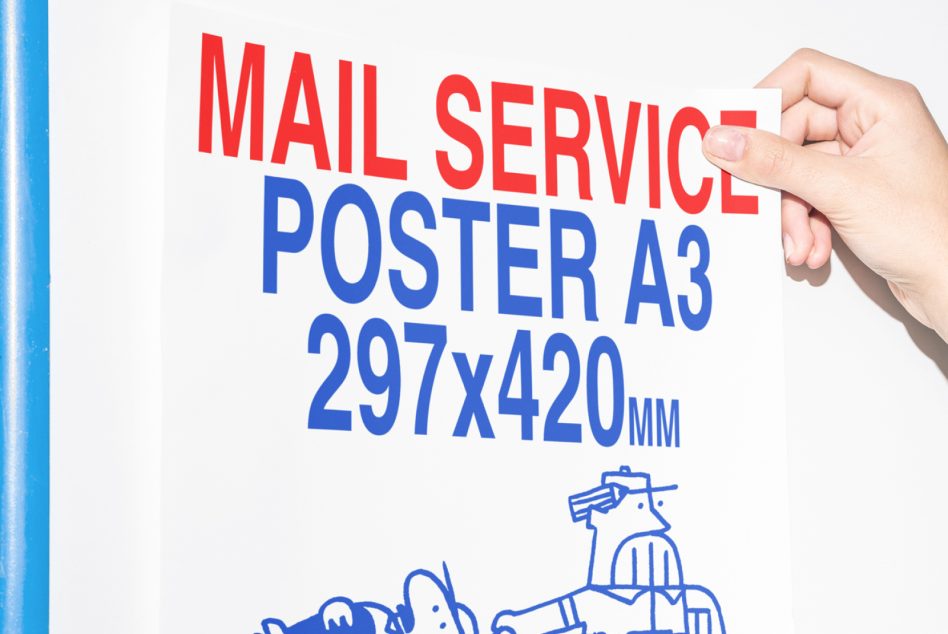 Hand holding A3 poster mockup with red mail service text on white background