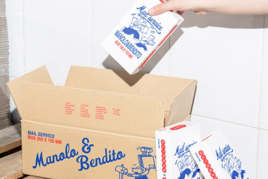 Person putting packaged design with hand-drawn elements into cardboard box. Keywords: mockup, packaging, graphic design, template, designer assets, mail service.
