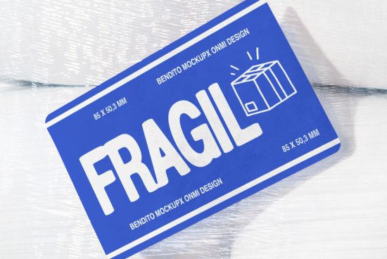 Blue fragile sticker mockup on shrink-wrapped surface, featuring bold white text and a box icon. Perfect for packaging design projects and mockup templates for designers.