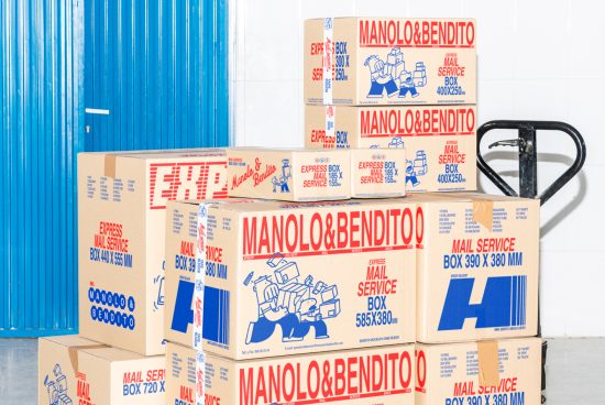 Stacked cardboard boxes with text Manolo Bendito Mail Service. Blue and red design on boxes, blue corrugated wall background. Packaging mockup graphic design.